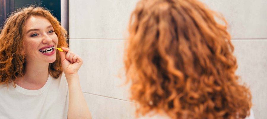 Photo of happy charming girl waking up and brushing teeth in home enjoying oral hygiene teeth cleaning