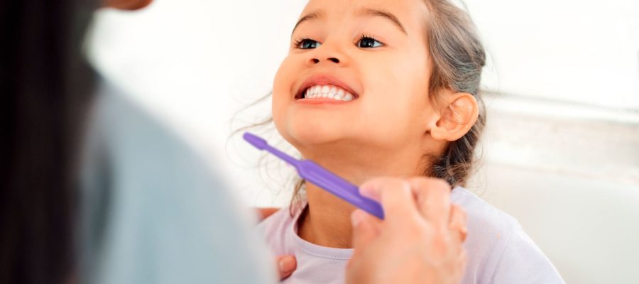 Look at how theyre shining. Shot of a mother helping her little daughter brush her teeth in the bathroom at home.